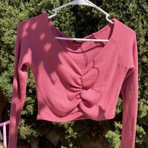 Pink long-sleeved crop top.